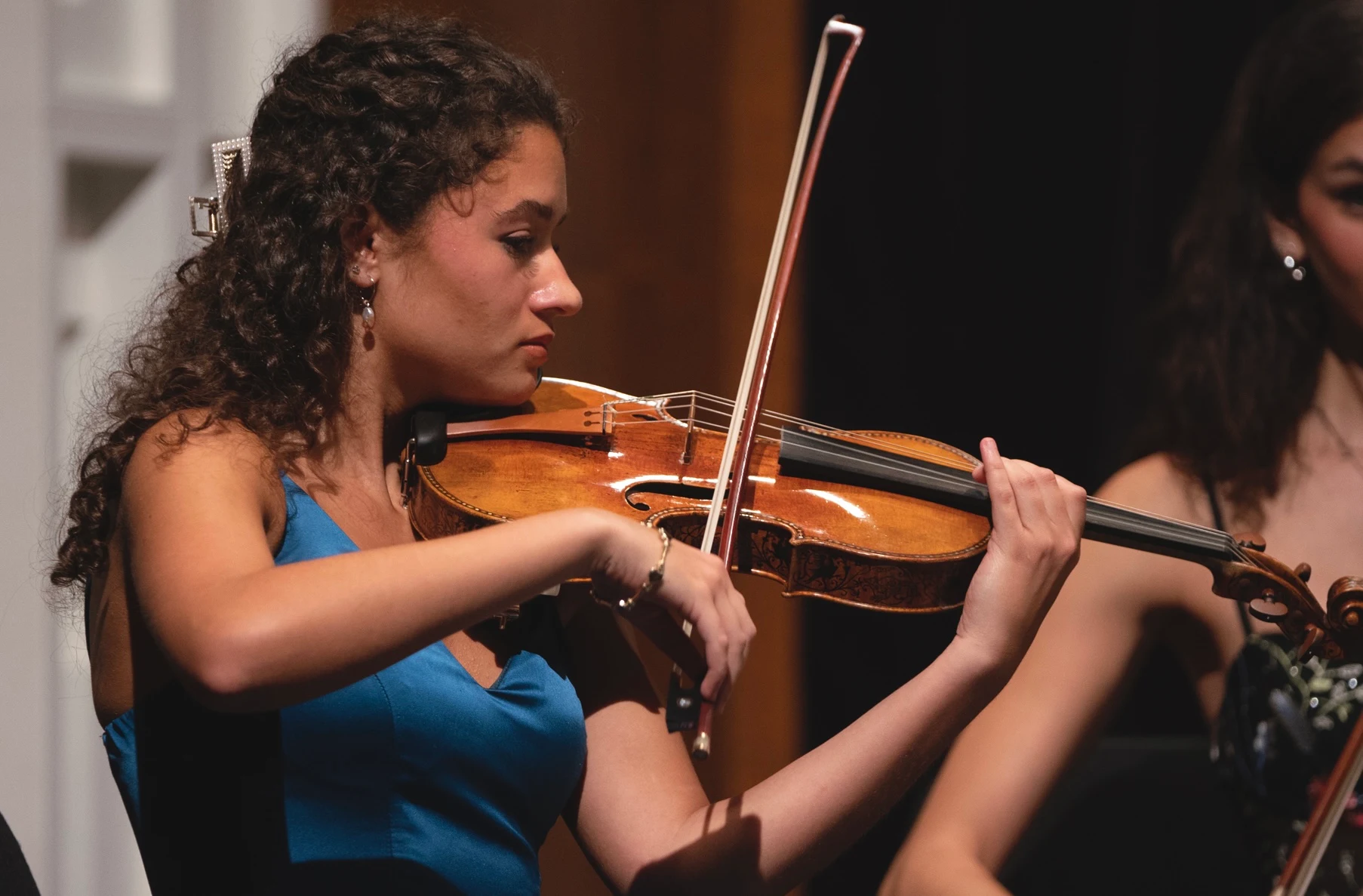 Victoria playing the violin during a performance